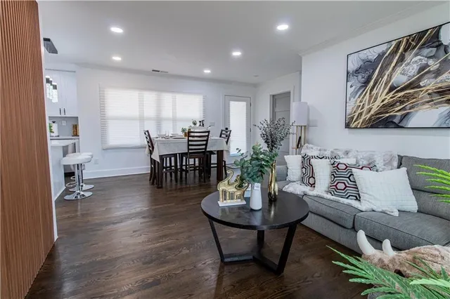 a living room with furniture and wooden floor