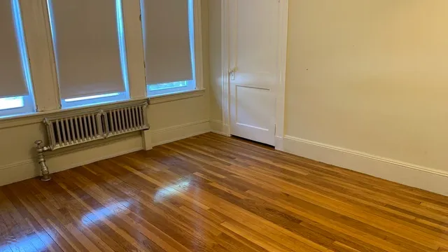 a view of a room with wooden floor and chair