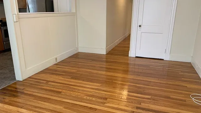 a view of a room with wooden floor