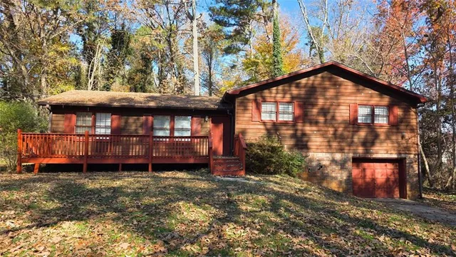 a view of a house with a yard and wooden fence