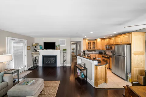 a large kitchen with granite countertop a large window and stainless steel appliances