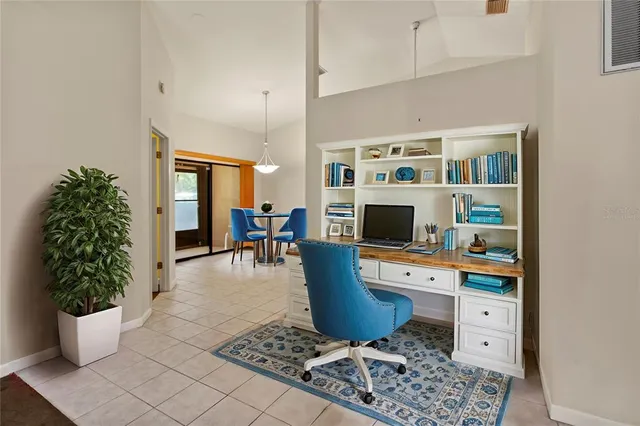 a view of a dining room with furniture and a chandelier