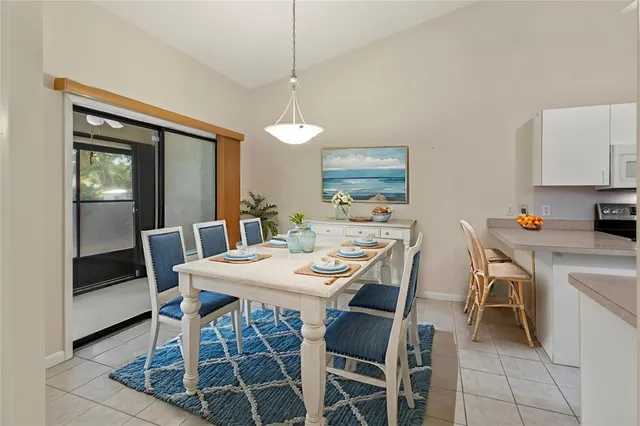a view of a dining room with furniture and a chandelier