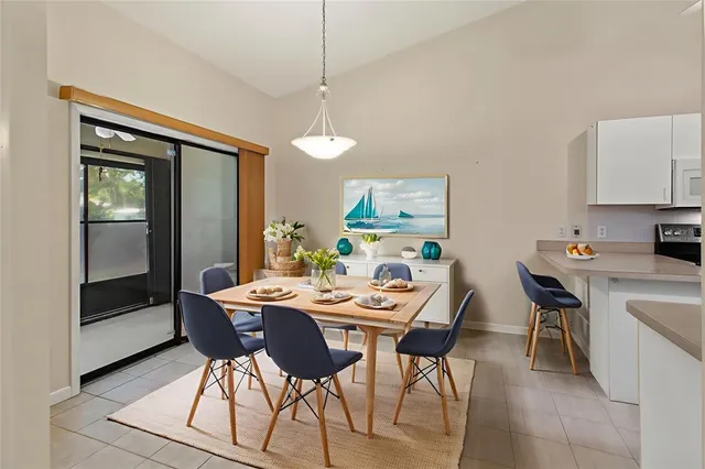 a kitchen with a sink a refrigerator and cabinets