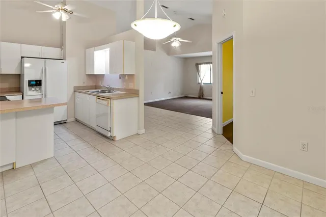 a kitchen with granite countertop a sink a stove and refrigerator
