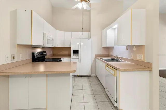 a kitchen with a sink and a refrigerator