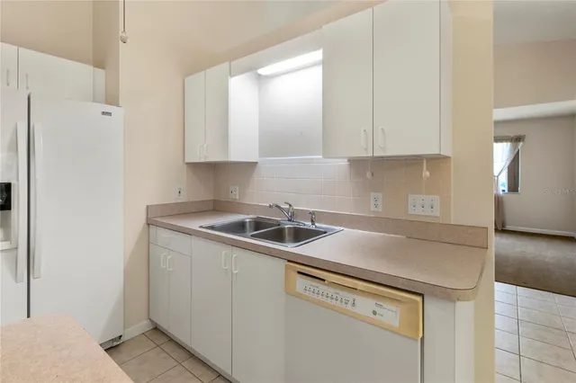 an empty room with a ceiling fan and a window