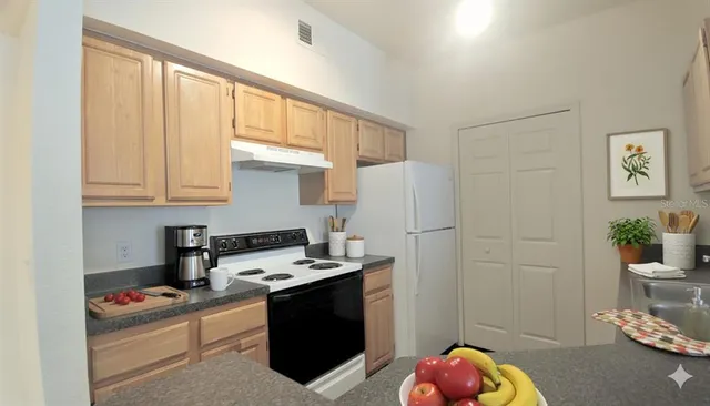 a kitchen with a refrigerator and a stove