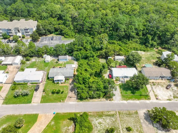 an aerial view of residential houses with outdoor space