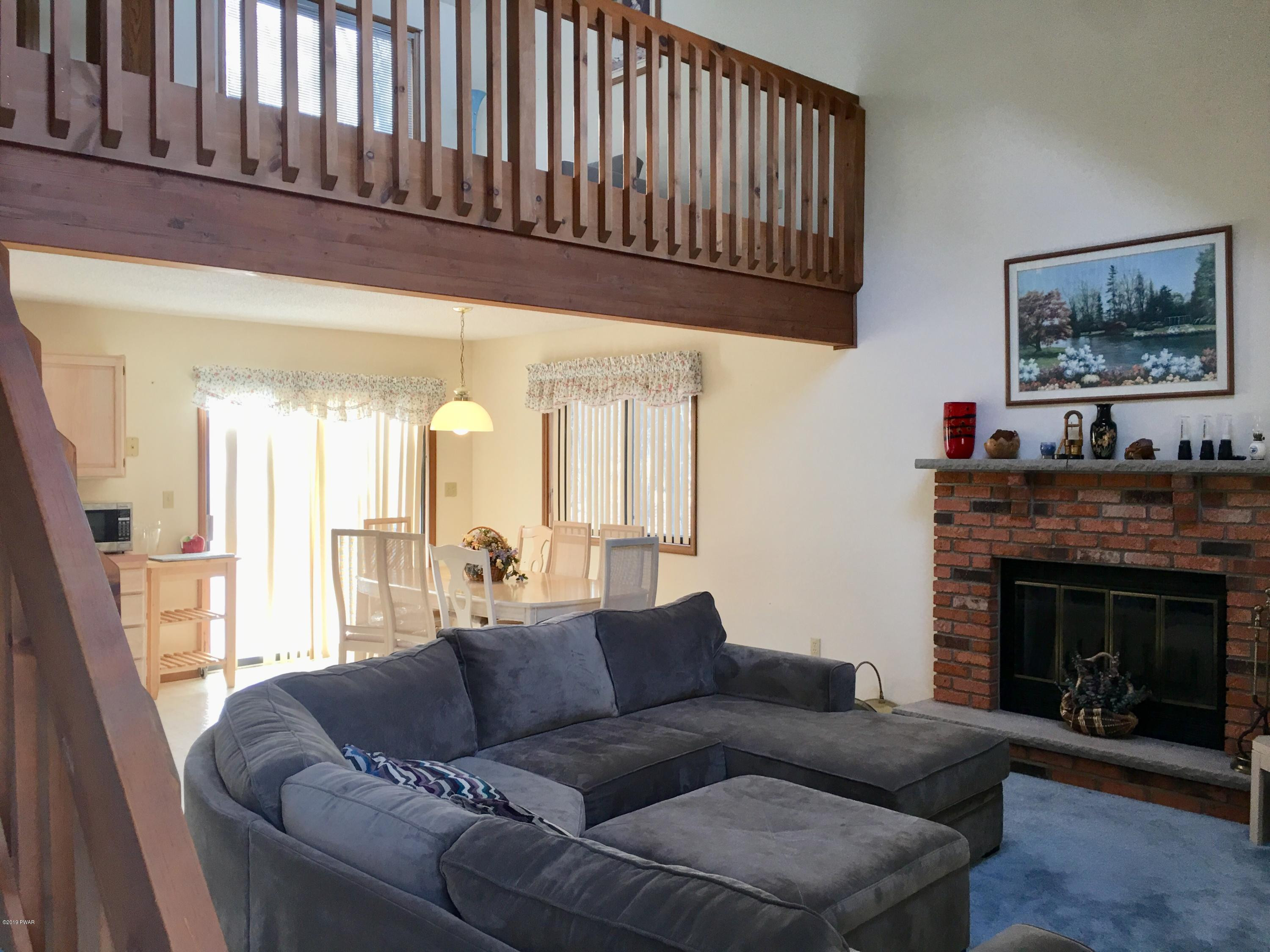 2375 Crest View Road Lake Ariel, PA 18436 - Photo 7 of 30 a living room with furniture a fireplace and a large window