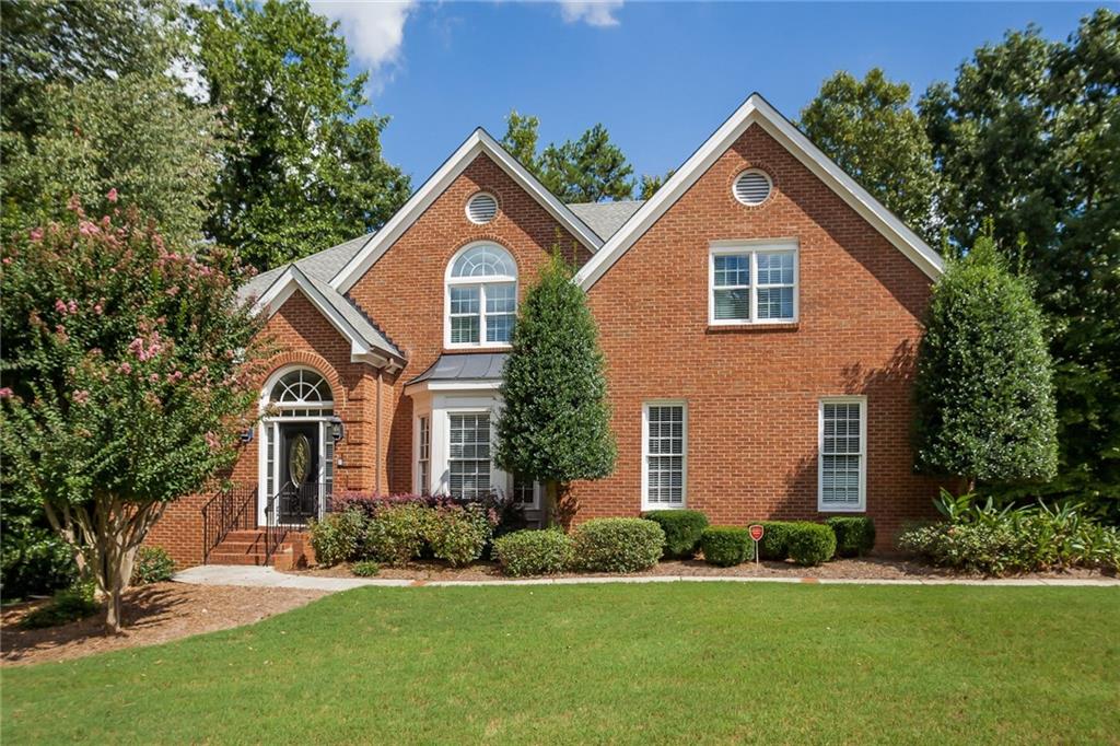 5135 Falcon Chase Lane Northeast Atlanta, GA 30342 - Photo 1 of 1 Front view of this convenient inside-285 Master on Main brick home with all three levels hardwoods throughout home! Level front yard with side entry garage as well as huge parking pad space for basketball or other games.