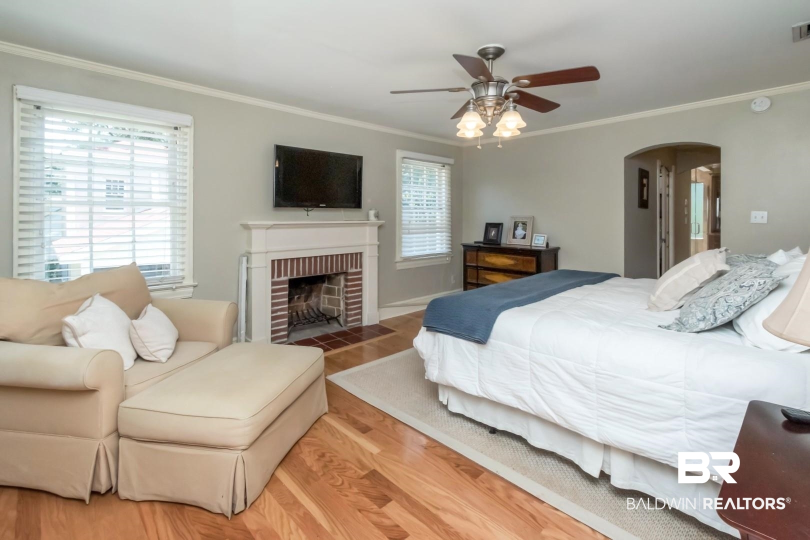 116 Florence Place Mobile, AL 36607 - Photo 22 of 41 Bedroom featuring a fireplace, crown molding, light wood-type flooring, and ceiling fan