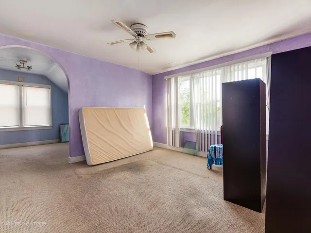 a view of room with a ceiling fan and a window