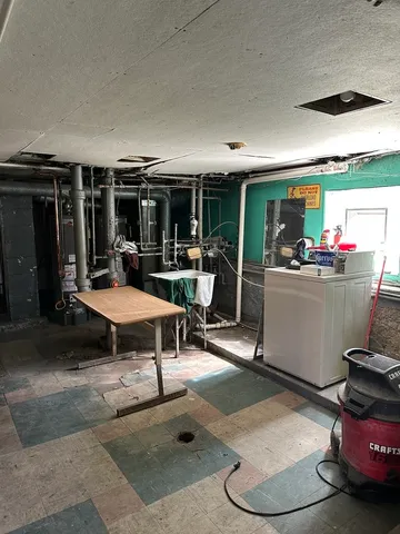 a living room with furniture a window and kitchen view