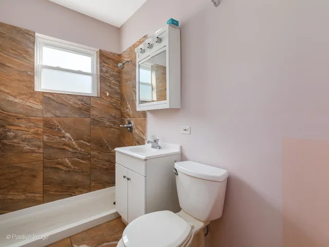 a white toilet sitting next to a bathroom sink