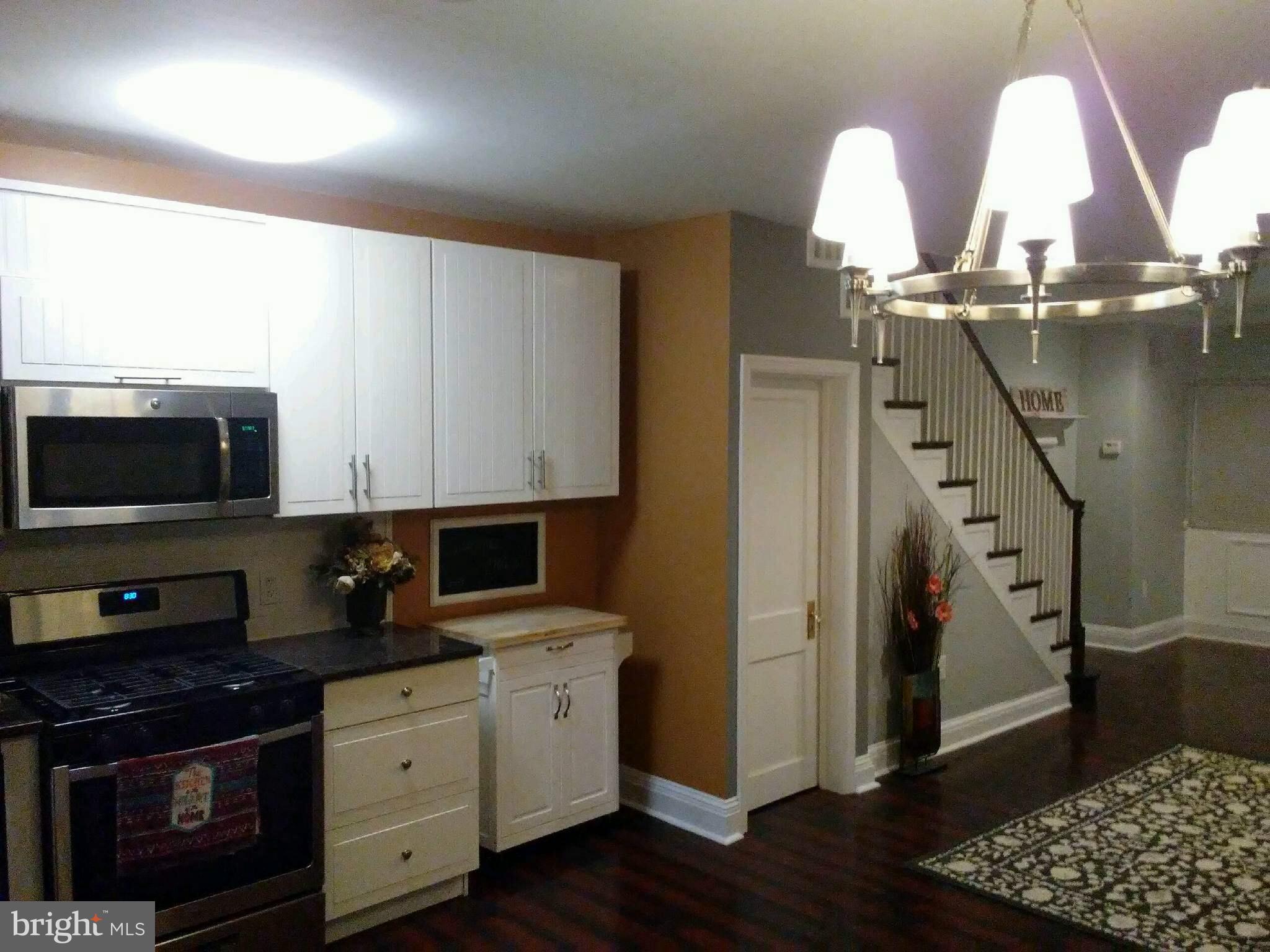 3733 Elkader Road Baltimore, MD 21218 - Photo 1 of 26 a kitchen with stainless steel appliances granite countertop a stove a sink and a microwave