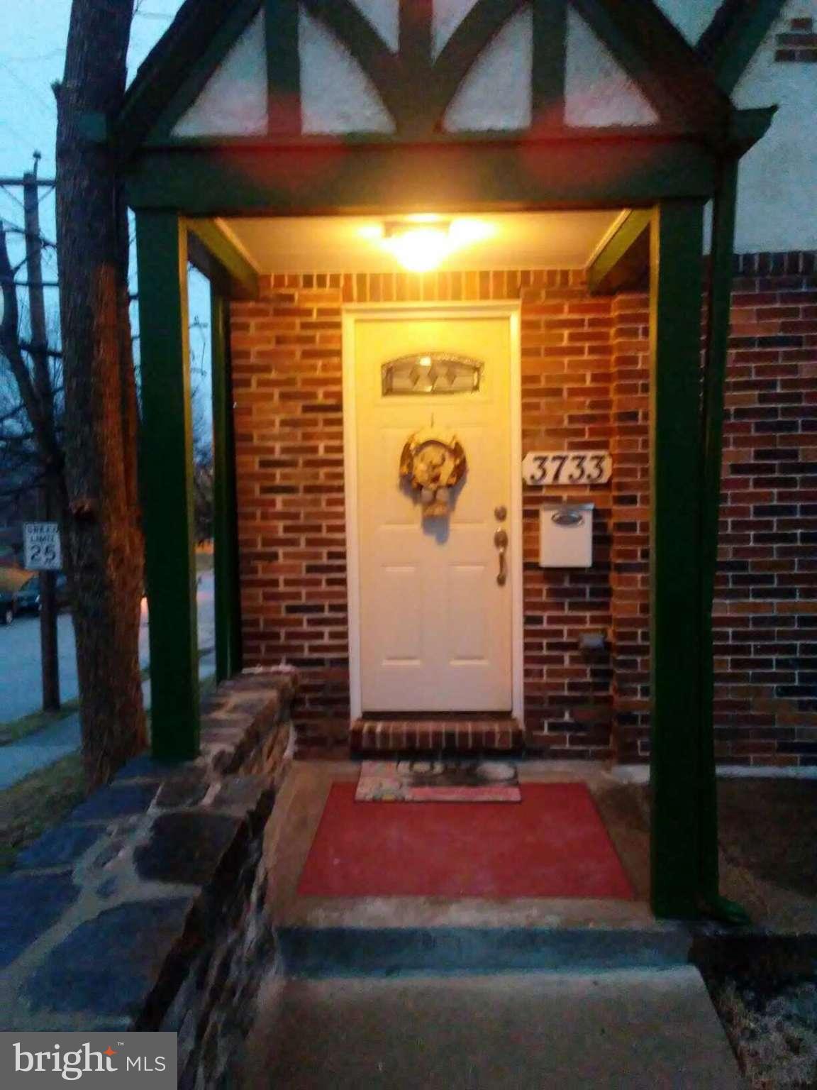 3733 Elkader Road Baltimore, MD 21218 - Photo 2 of 26 a front view of a house with a yard