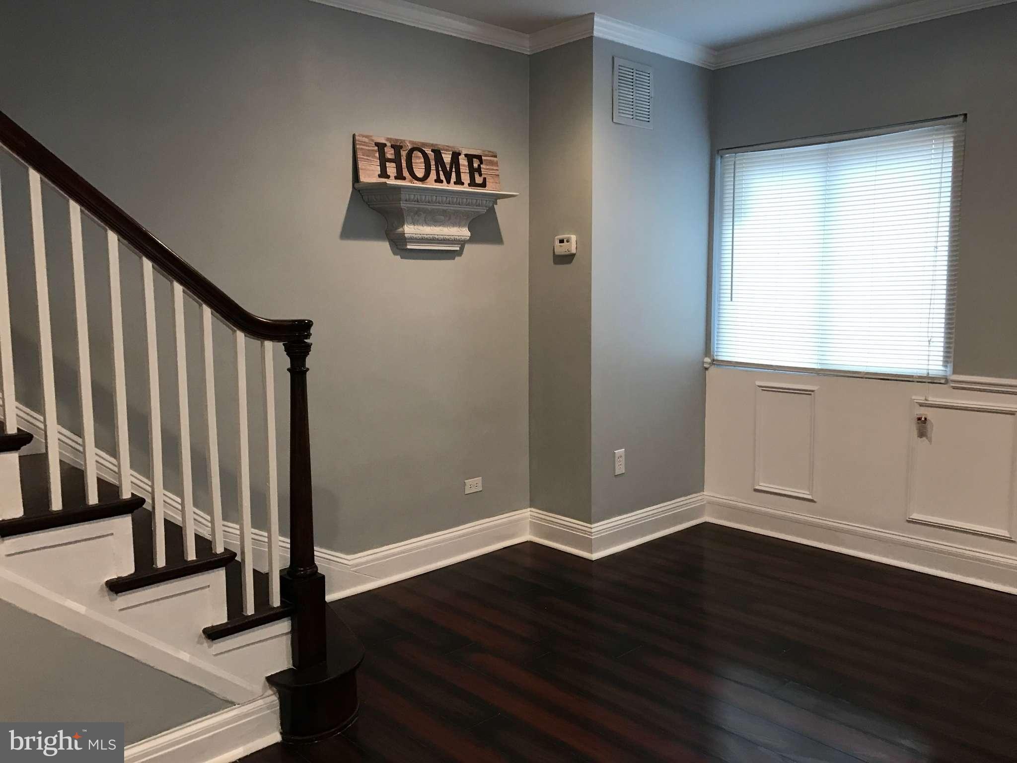 3733 Elkader Road Baltimore, MD 21218 - Photo 11 of 26 a view of a hallway with wooden floor and stairs