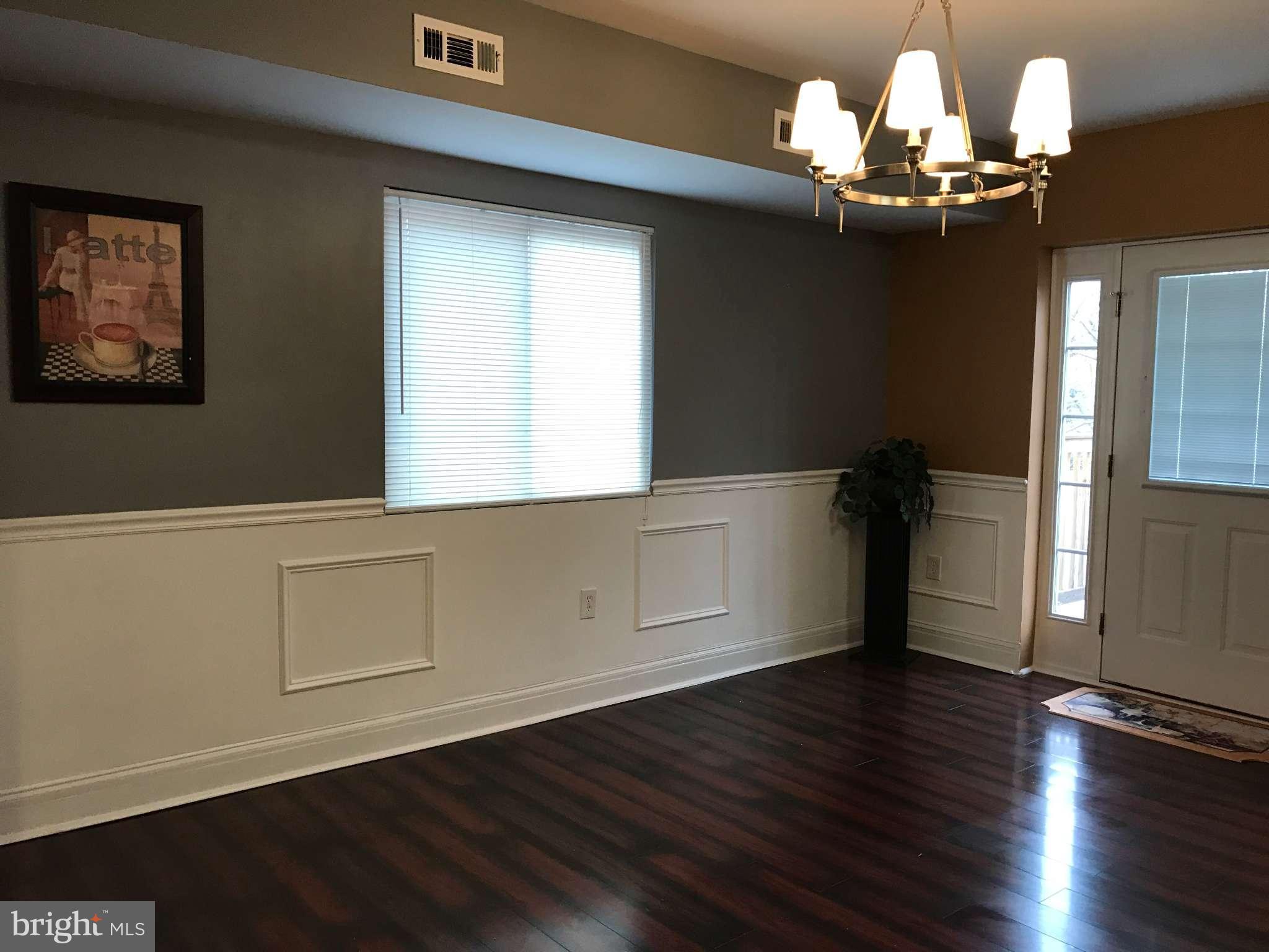 3733 Elkader Road Baltimore, MD 21218 - Photo 12 of 26 a view of a room with wooden floors and chandelier