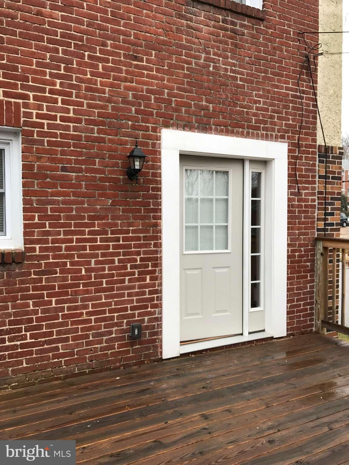 3733 Elkader Road Baltimore, MD 21218 - Photo 14 of 26 a view of front door of house with wooden floor