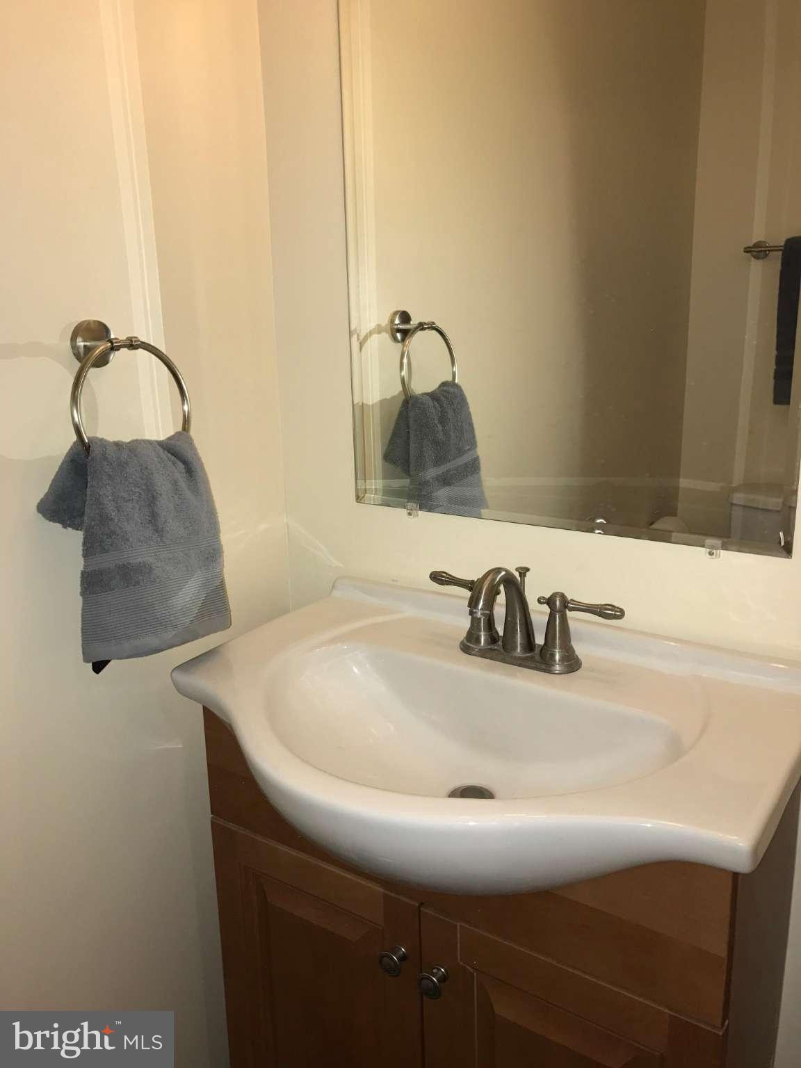 3733 Elkader Road Baltimore, MD 21218 - Photo 23 of 26 a bathroom with a sink and a mirror