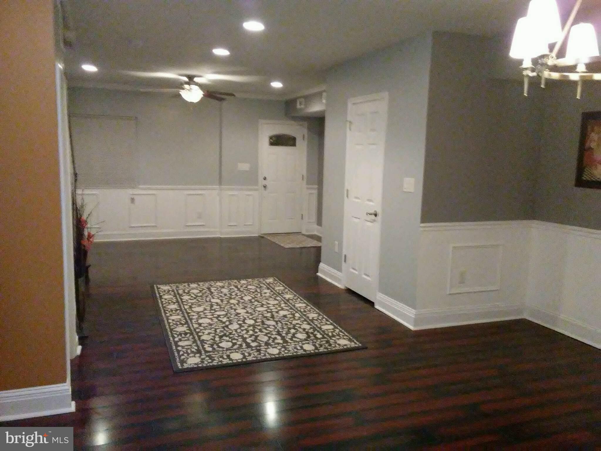 3733 Elkader Road Baltimore, MD 21218 - Photo 7 of 26 a view of an empty room with wooden floor and a bathroom