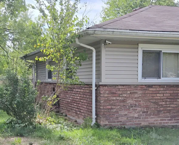 a front view of a house with brick walls
