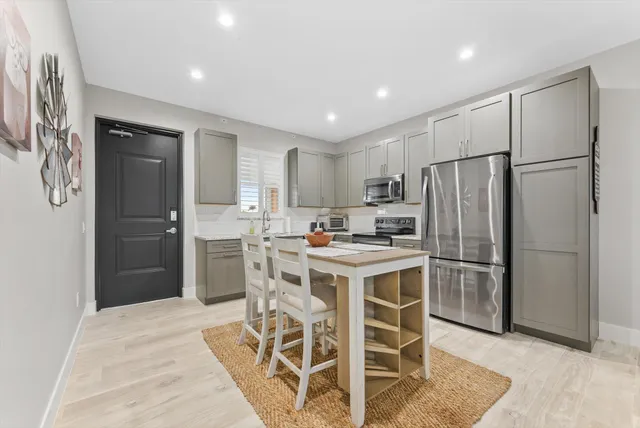 a kitchen with stainless steel appliances a refrigerator stove microwave and cabinets