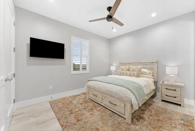 a bedroom with a large bed and a flat screen tv