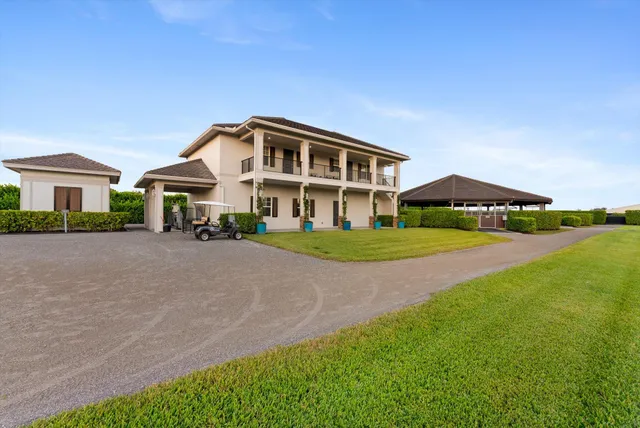 a front view of a house with yard and green space