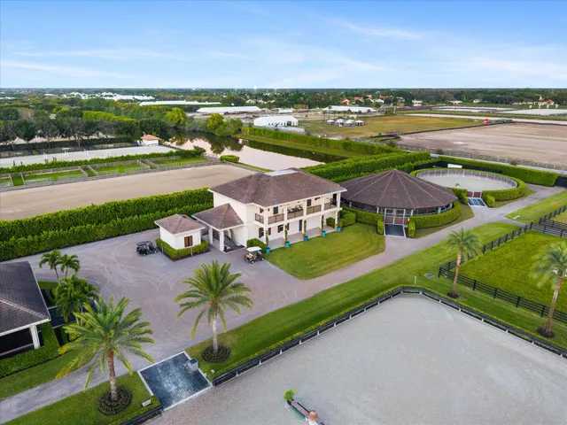 an aerial view of residential houses with outdoor space and ocean view