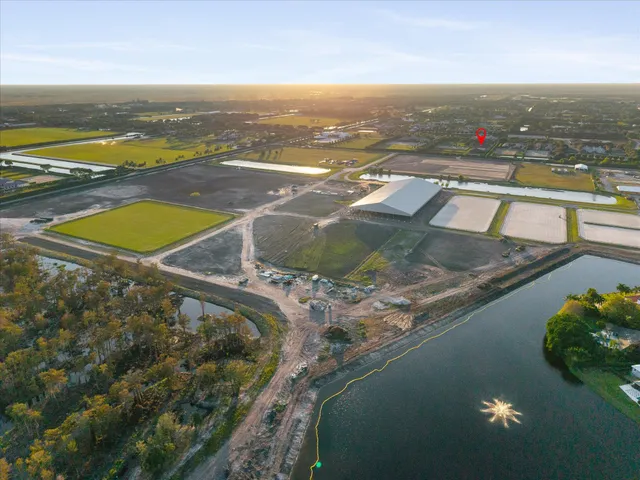 an aerial view of residential houses with outdoor space and ocean view