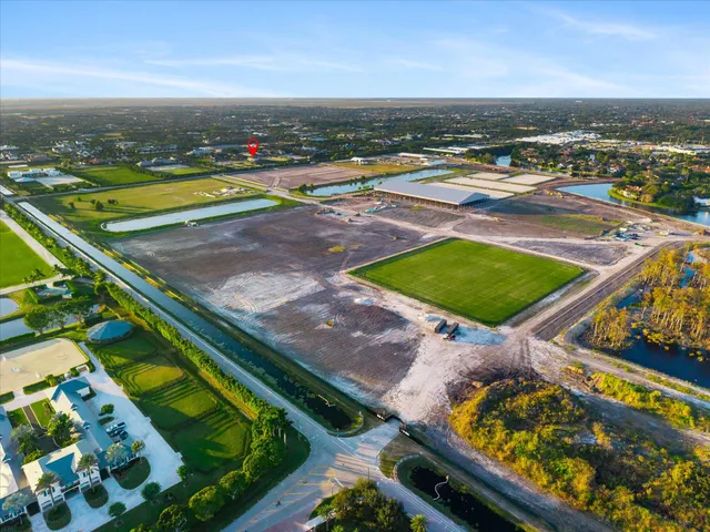an aerial view of a tennis ground and a houses