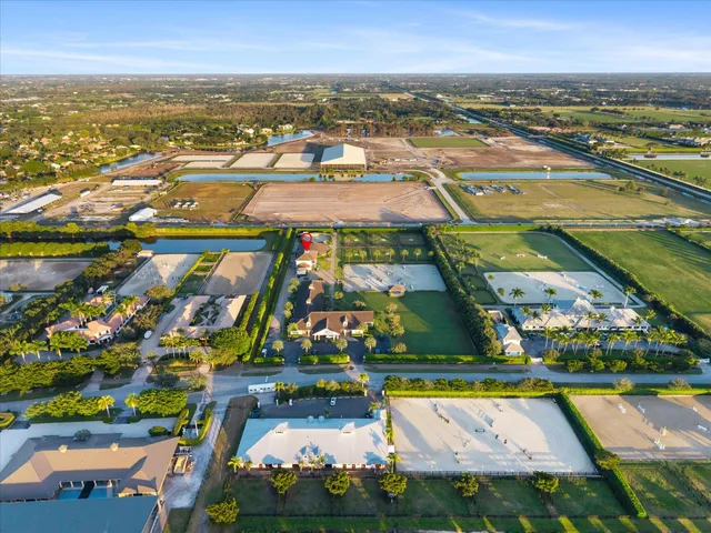 an aerial view of residential houses with outdoor space and swimming pool