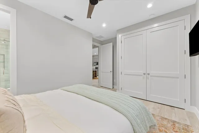 a bedroom with a bed and a flat tv screen