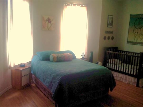16 Beacon Street, Unit 11 Chelsea, MA 02150 - Photo 11 of 14 a bedroom with a bed and wooden floor