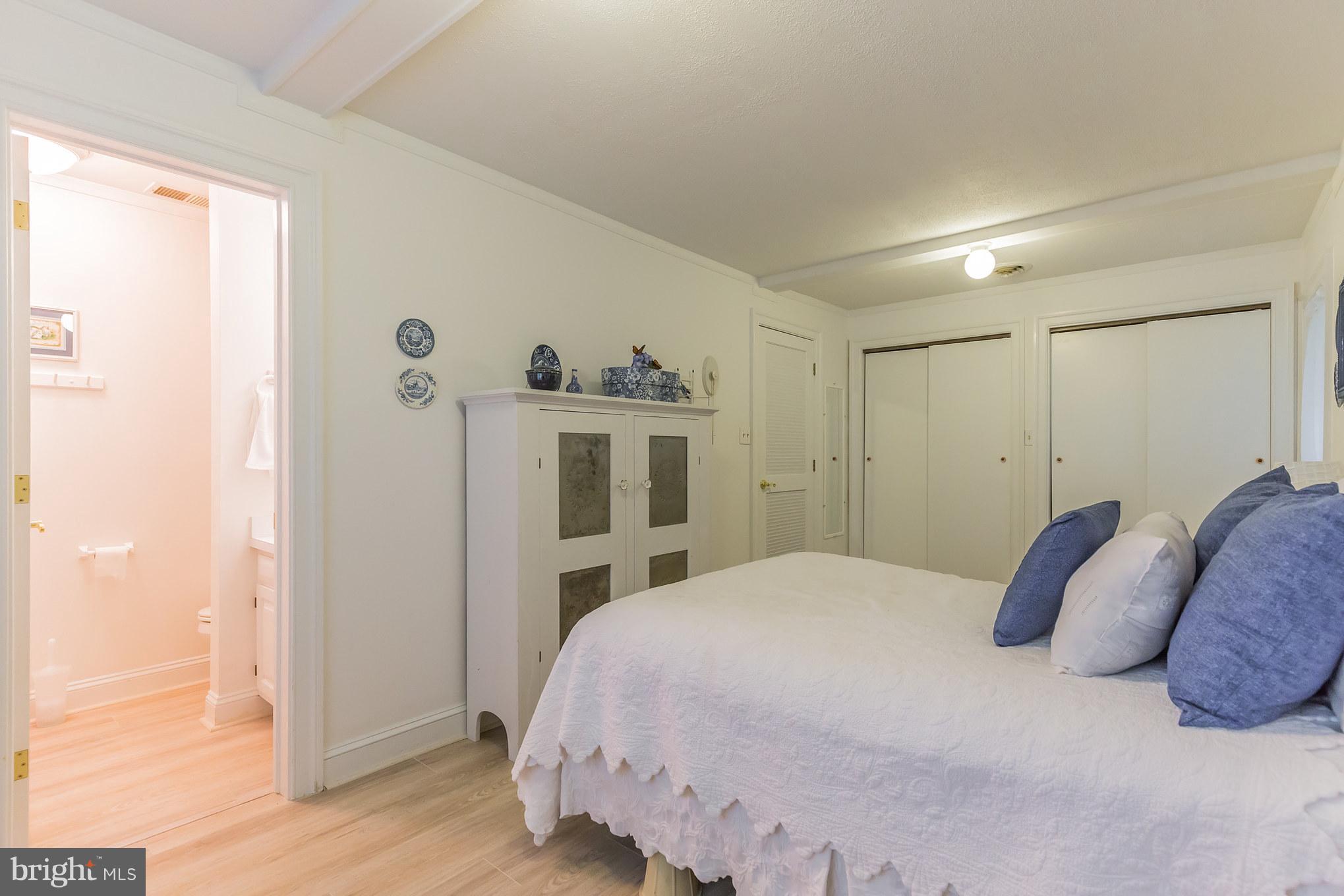 510 Swaggers Point Road Solomons, MD 20688 - Photo 18 of 30 a bedroom with a bed and a mirror