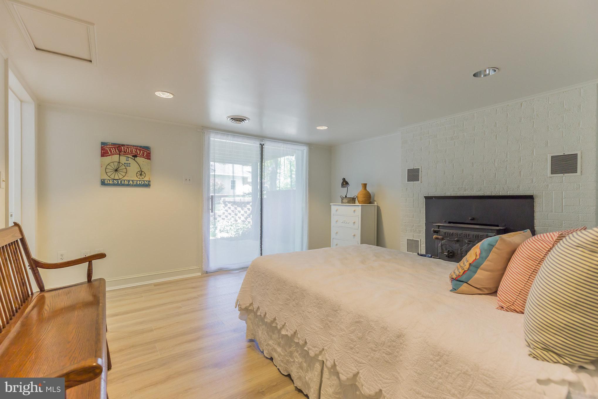 510 Swaggers Point Road Solomons, MD 20688 - Photo 20 of 30 a bedroom with a large bed and a wooden floor