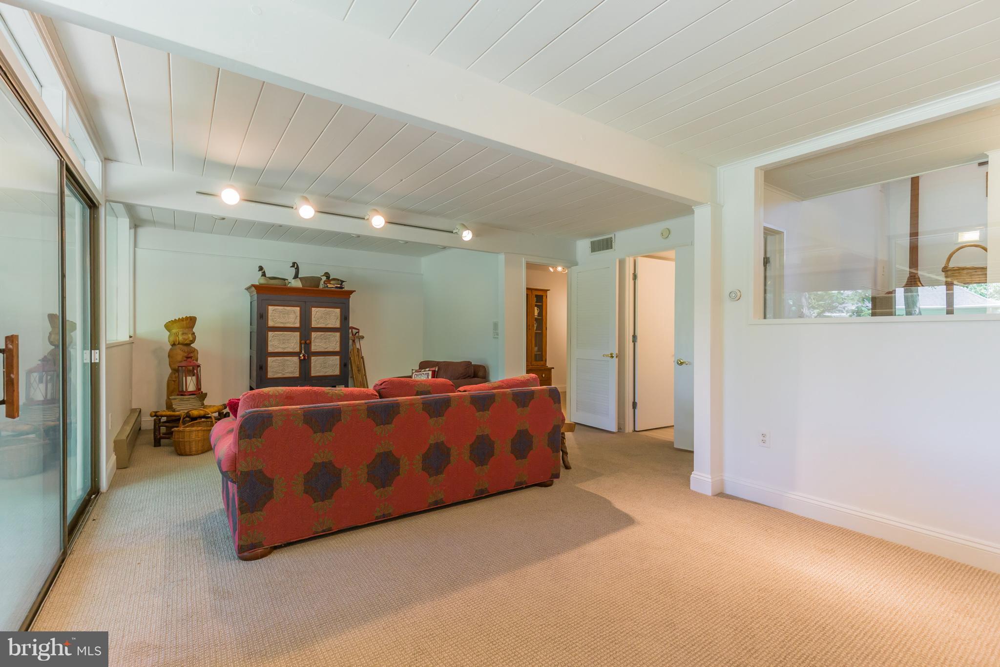 510 Swaggers Point Road Solomons, MD 20688 - Photo 21 of 30 a spacious bedroom with a bed and a walk in closet