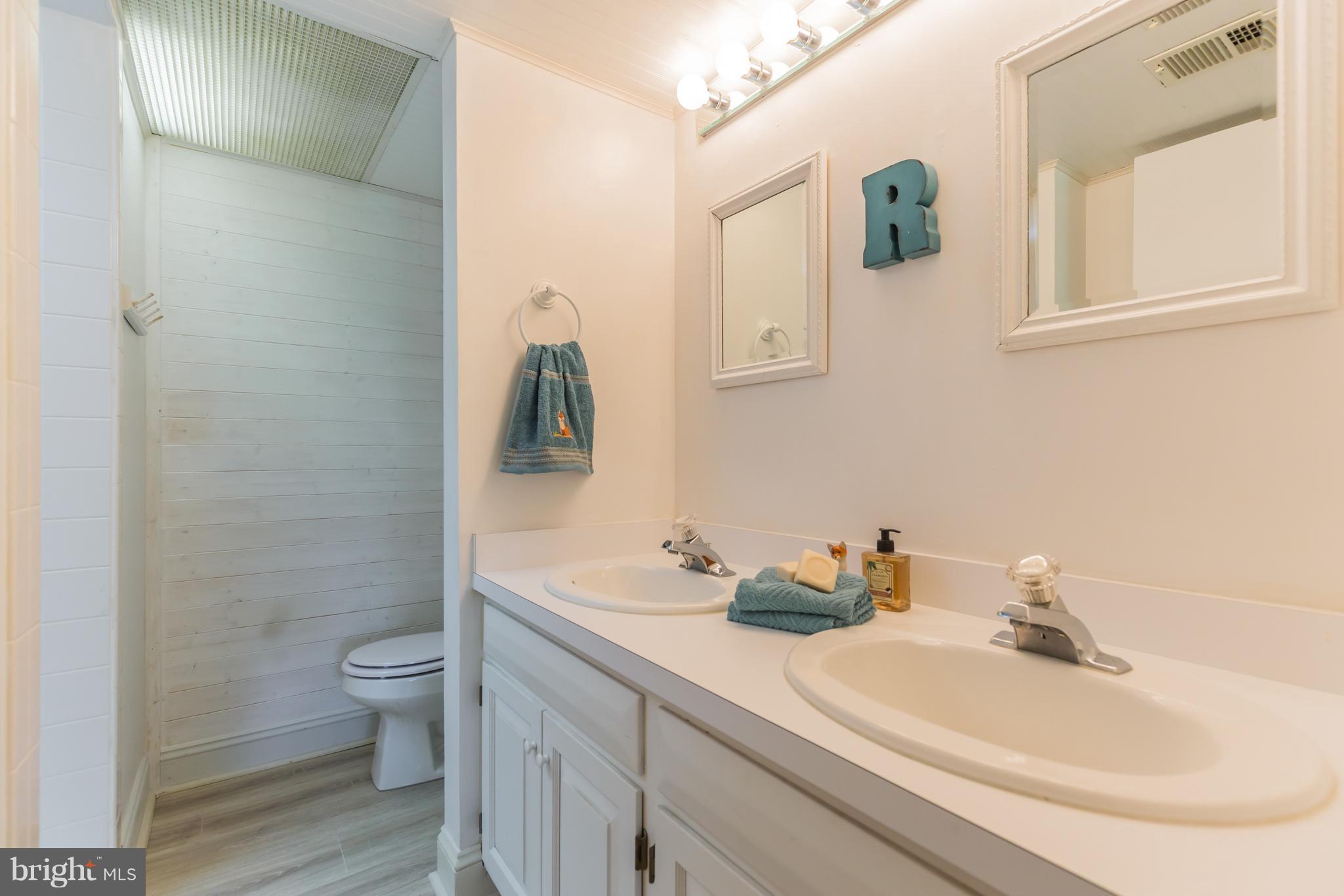 510 Swaggers Point Road Solomons, MD 20688 - Photo 23 of 30 a bathroom with a sink and a mirror