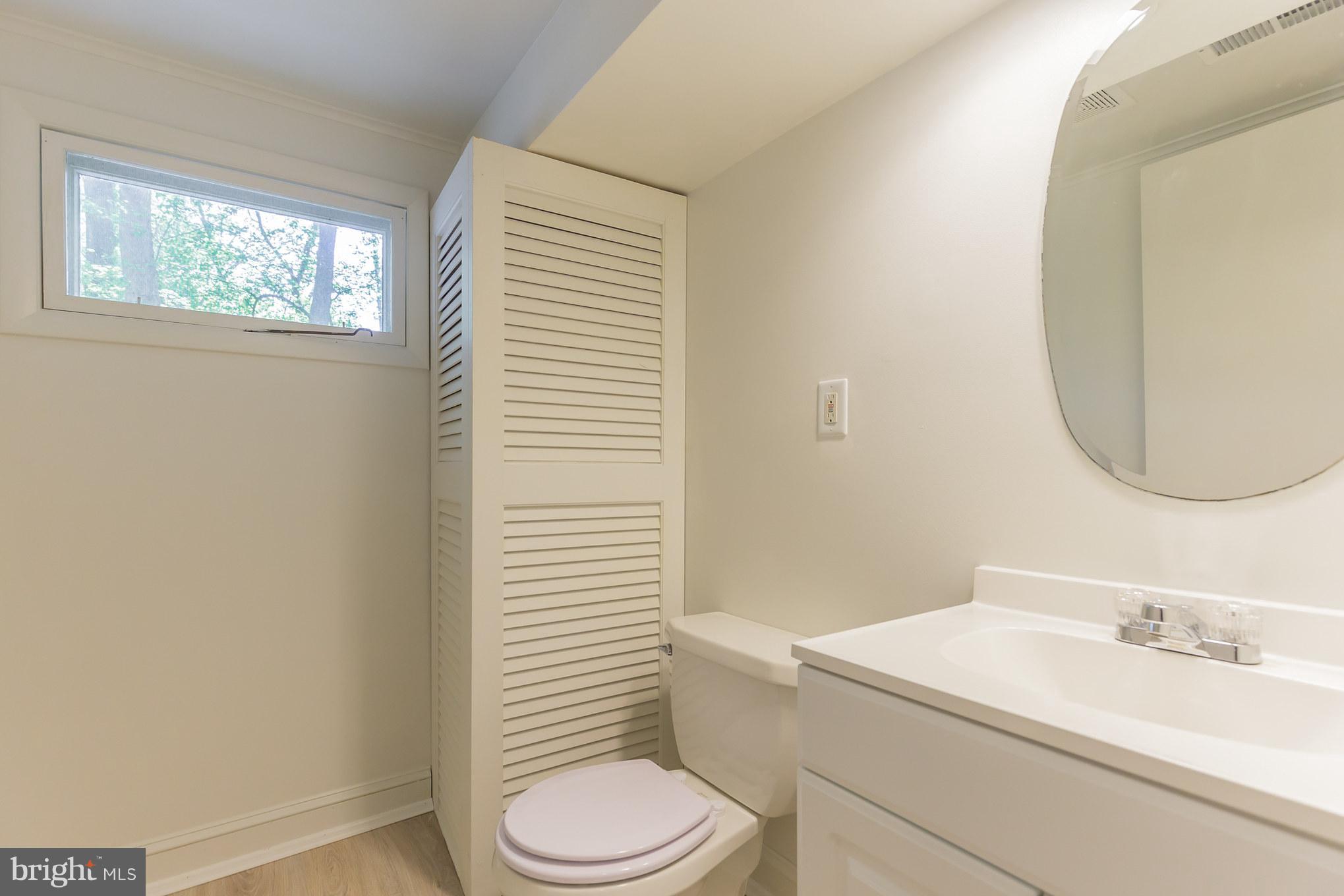 510 Swaggers Point Road Solomons, MD 20688 - Photo 25 of 30 a bathroom with a toilet a sink and a mirror