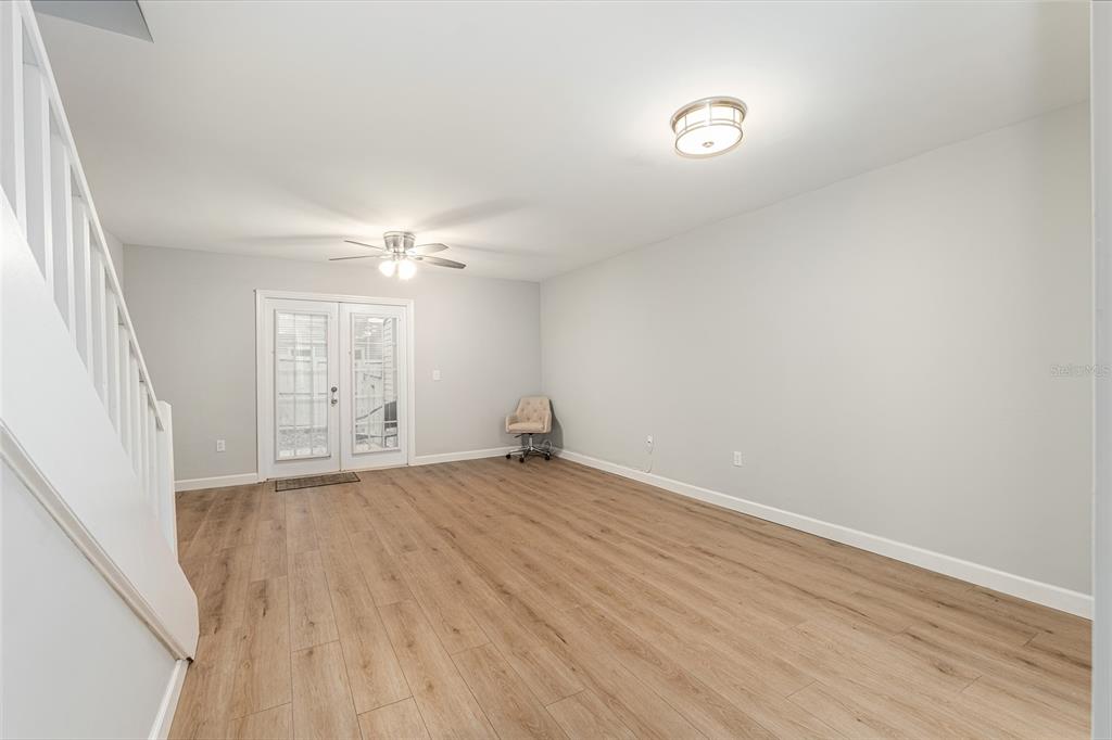 5240 Southwest 92nd Court Gainesville, FL 32608 - Photo 15 of 58 an empty room with wooden floor and windows