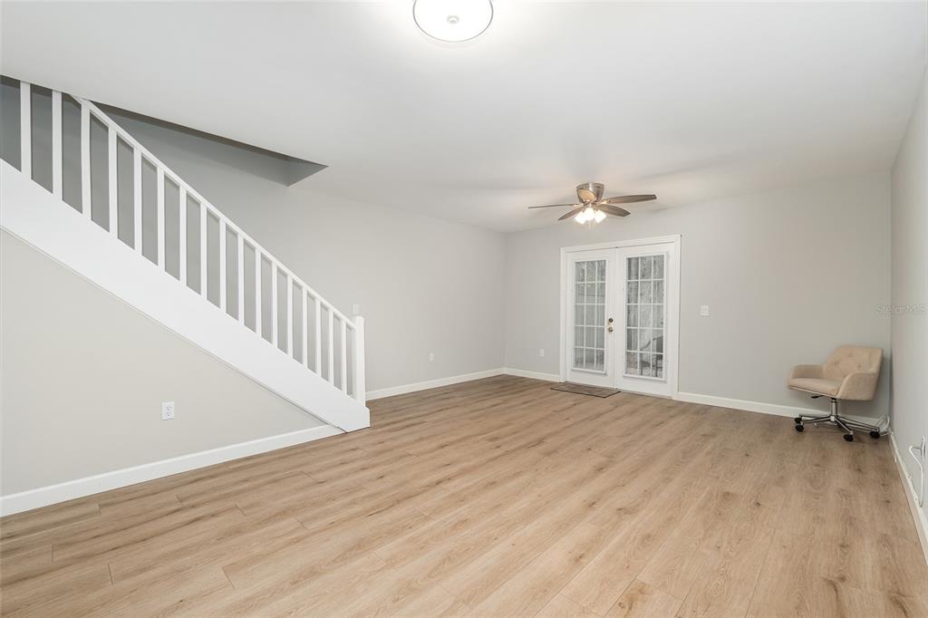 5240 Southwest 92nd Court Gainesville, FL 32608 - Photo 16 of 58 a view of an empty room with a window and wooden floor