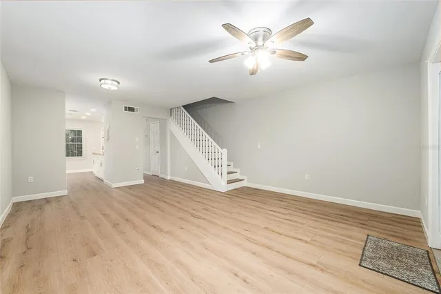 a kitchen with stainless steel appliances granite countertop white cabinets and a stove top oven