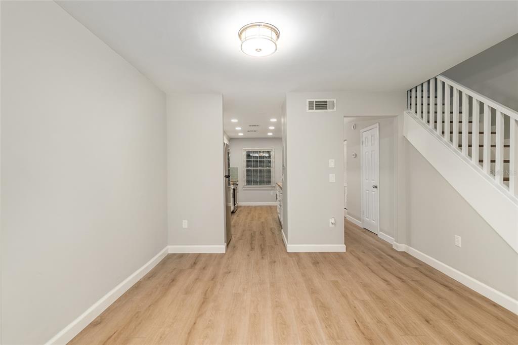 5240 Southwest 92nd Court Gainesville, FL 32608 - Photo 20 of 58 a view of a hallway with wooden floor and staircase