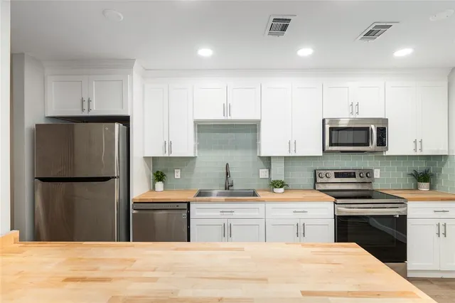a bathroom with a sink mirror and vanity