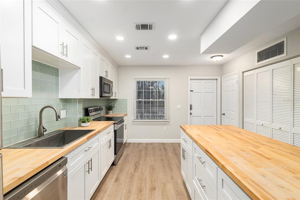 5240 Southwest 92nd Court Gainesville, FL 32608 - Photo 25 of 58 a kitchen with a sink stove and cabinets