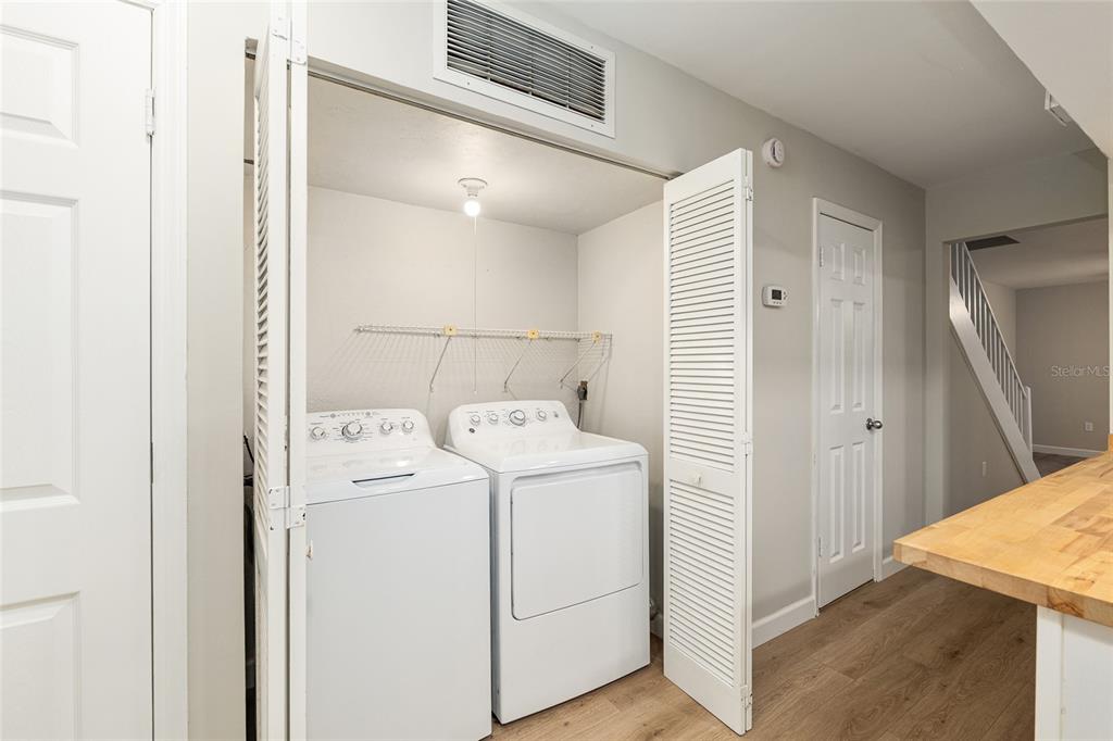 5240 Southwest 92nd Court Gainesville, FL 32608 - Photo 27 of 58 a view of washer and dryer with wooden floor