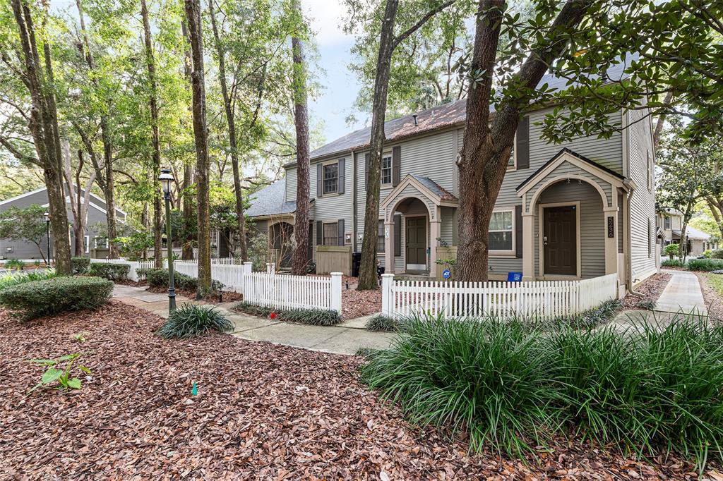 5240 Southwest 92nd Court Gainesville, FL 32608 - Photo 3 of 58 a front view of a house with garden and trees