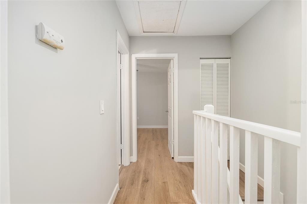 5240 Southwest 92nd Court Gainesville, FL 32608 - Photo 33 of 58 a view of a hallway with wooden floor